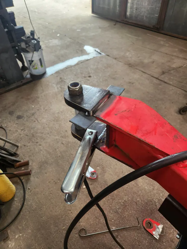 A replacement component for agricultural equipment with a worn, oval hole.