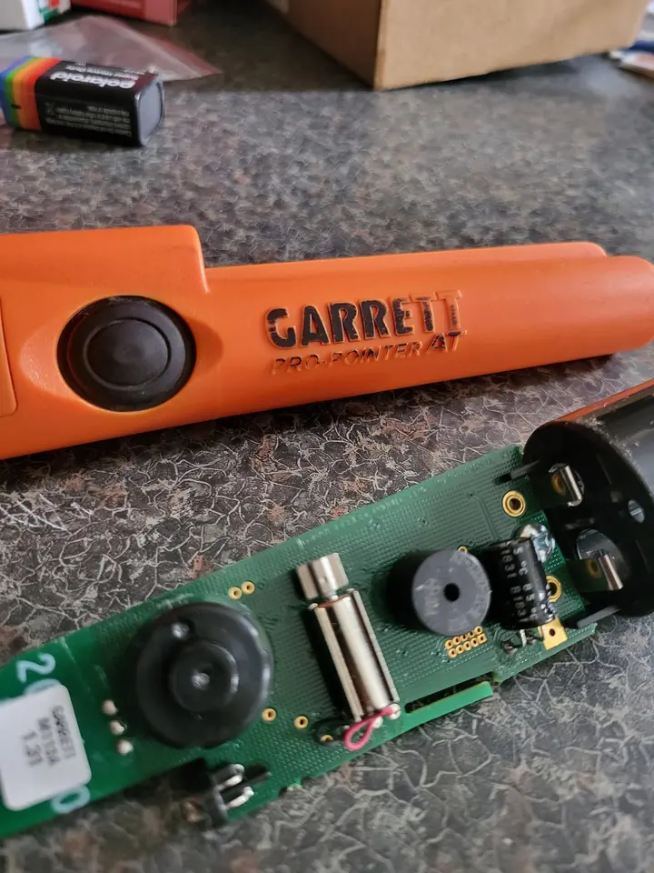 The opened Garrett pinpointer metal detector during an electronics repair.